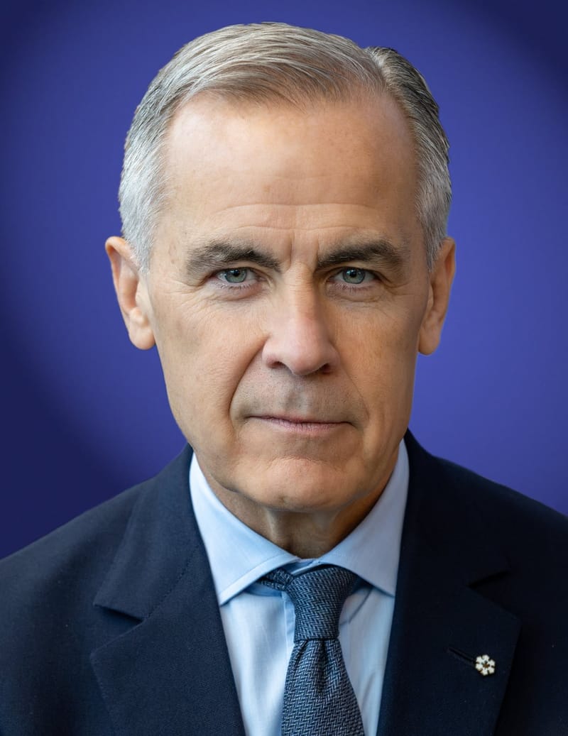 Mark Carney, de cabelo grisalho, terno escuro, camisa azul-clara e gravata azul, em retrato de frente sobre fundo azul