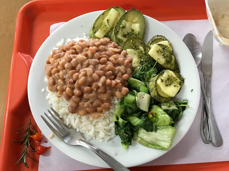 Prato com arroz, feijão e legumes refogados, servido em bandeja de restaurante no Brasil