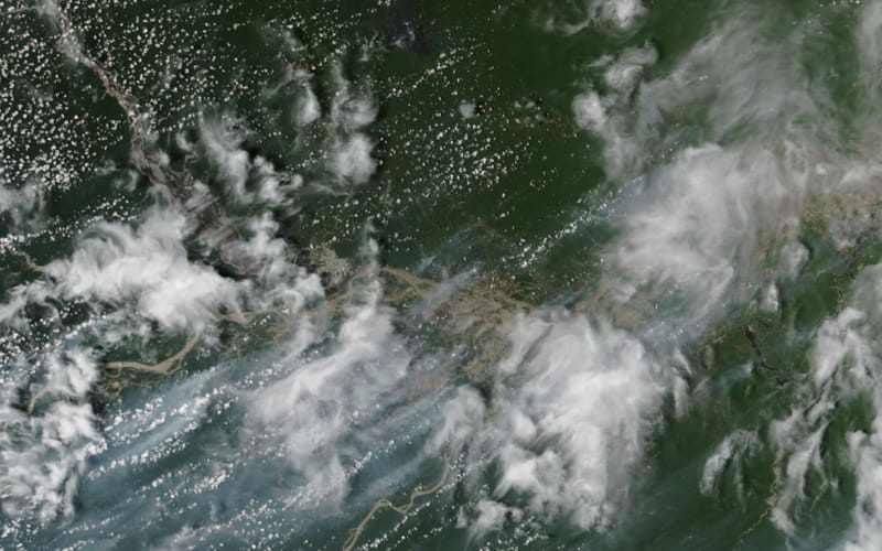 Imagem de satélite da região de Manaus com a floresta verde, os rios Negro e Solimões e faixas acinzentadas de fumaça de queimadas ao sul