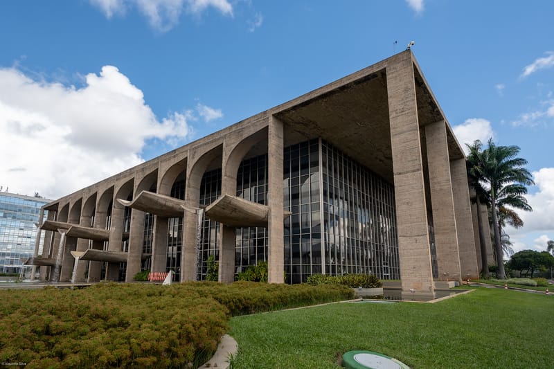 Fachada do Palácio da Justiça, sede do Ministério da Justiça, com arcos de concreto e cascatas de água, sob céu azul